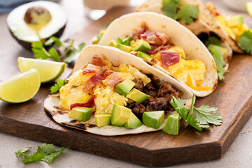 Breakfast tacos with sausage, eggs, bacon and avocado