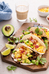Breakfast tacos with sausage, eggs, bacon and avocado