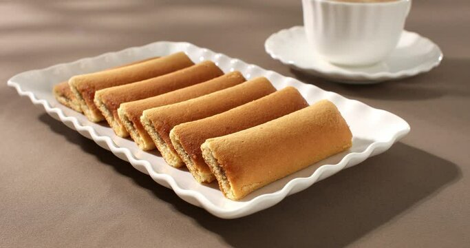 cookies with a cup of coffee on the table. strudel with fruit filling on a white plate. pastries on a brown background. sweet treat on a sunny day. Generative AI