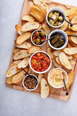 Fototapeta na wymiar Snack board with toasted baguette and variety of dips