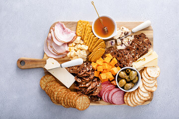 Charcuterie board or cheese board with a variety of cheeses, meat and snacks