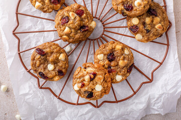 White chocolate and cranberry cookies on a cooling rack