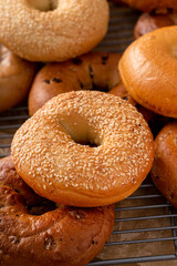 Variety of freshly baked bagels on a cooling rack