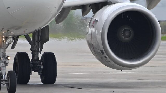 Huge airplane jet engine close up view moving forward heat haze distant airplane lining up behind. 4k super slow motion raw video 120 fps Generative AI