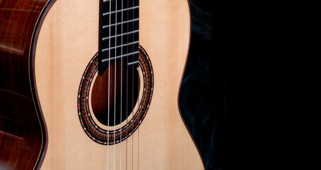 Close up shot of Classical guitar show the rosette around sound hole , black background