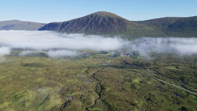 Flying towards remaining low fog and the A82 road at Glencoe, Scotland