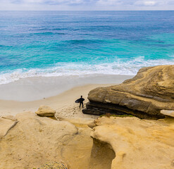 Surfer on The Beach Below The Sea Cliffs on South Casa Beach, La Jolla, California, USA
