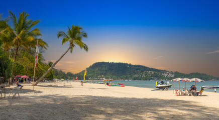 Patong Beach Phuket Thailand nice white sandy beach clear blue and turquoise waters and lovely blue skies with Palms tree