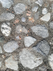 Top view of a fragment of a dirt road. Rubble stones of different fractions on the ground. Abstract natural textured background. Drainage layer.