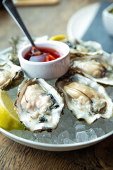 Fresh oyster and red vinaigrette on ice