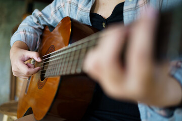 Happy young Woman hands playing acoustic guitar musician  alone compose instrumental song lesson on playing the guitar