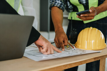 multi ethnic engineer brainstorming and measuring for cost estimating on paperworks and floor plan drawings about design architectural and engineering for houses and buildings