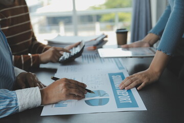 Brainstorming Collaboration and successful partnership analysis by Young business Asian people working in an office workspace