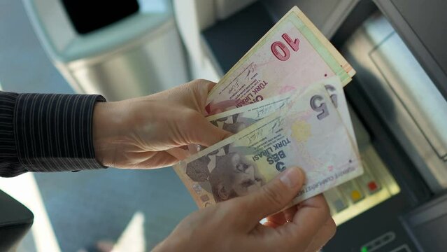 Business woman counting turkish lira near ATM machine  Generative AI