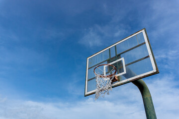 Low angle view of basketball ring on sky background. Outdoor basketball hoop.