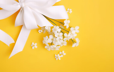 Spring rustic background of yellow cloth with white wildflowers, in the style of minimalist still life, water drops, pastel color scheme. Daisies, wedding still life with white ribbon. AI