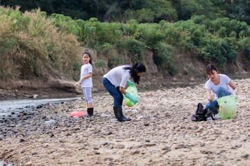Environment and pollution caring management concept, group of Asian friends collect dirty plastic...