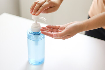 Hand applying Alcohol gel sanitazer liquid cleaning hands for prevent corona virus covid-19.