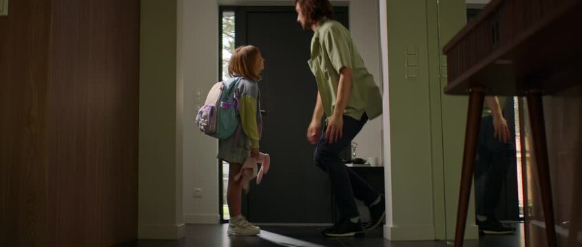Father is saying goodbye to his daughter before she is leaving to school on a schoolbus Generative AI