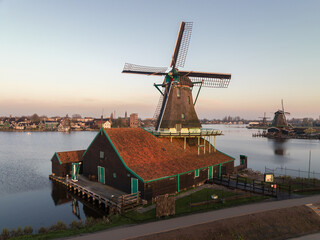 Fototapeta na wymiar Rural landscape with windmill in Zaanse Schans. Holland, Netherlands.