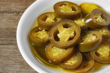 Close-up Pickled Jalapeno Pepper slices on a small plate