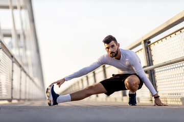 Fototapeta na wymiar Athletic man stretch and exercise on the brigde