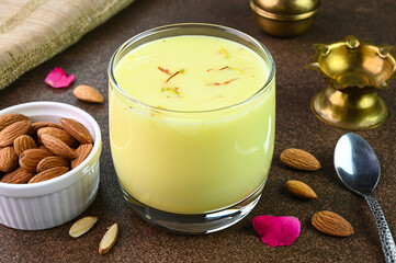 Badam milk drink served in a glass cup.