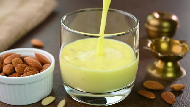 Serving badam drink in a glass cup.