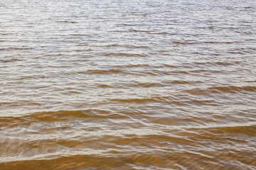 Transparent water on the Baltic Sea coast on a windy spring day. Jurmala, Latvia.