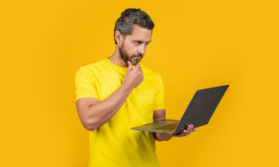 photo of busy man freelancer with laptop. man freelancer isolated on yellow. man freelancer