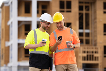 photo of engineer men using phone at construction site. engineer men at construction site.