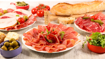 composition of delicatessen- baguette, salami,sausage,ham