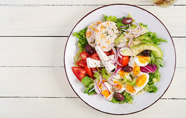 Chicken meatloaf and fresh vegetable salad of tomato, avocado, eggs, lettuce and feta cheese. Ketogenic, keto diet. Top view, overhead