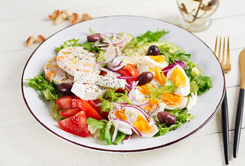 Chicken meatloaf and fresh vegetable salad of tomato, avocado, eggs, lettuce and feta cheese. Ketogenic, keto diet.
