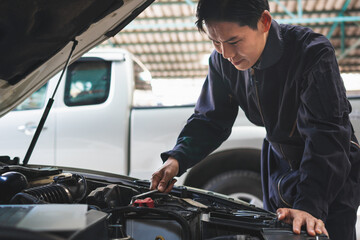 Fototapeta na wymiar Portrait of a mechanic repairing a car in garage, Auto mechanic working in garage, Maintenance and Repair service.