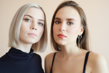 View of two young women on a light background.