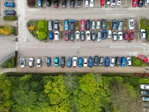 Drone top down view of many parked private cars. Located at a premier hotel in the rural English countryside.