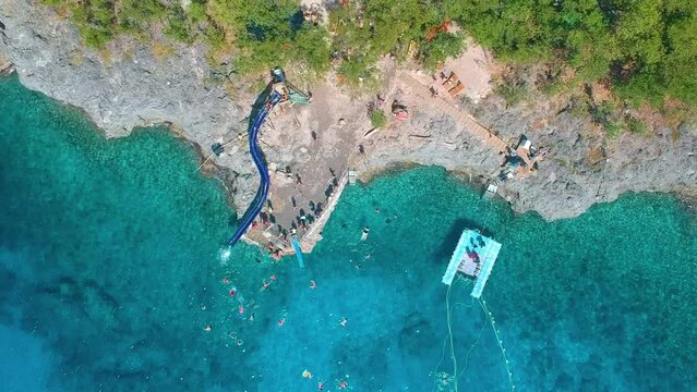 Aerial View Of Tourists Enjoying Water Slide At Eco Parque West View In San Andres Island, Colombia. - ascend