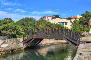 Fototapeta na wymiar The wooden pedestrian bridge in Porto Rotondo - Sardinia