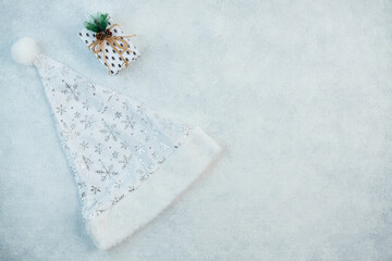 The concept of a festive background in silver tones. Top view of the silver balls from the gift box on a gray background. New Year's Holiday background layout with space to copy