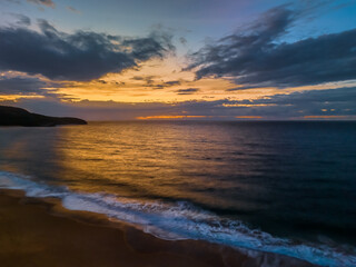 Sunrise seascape with clouds and gentle surf