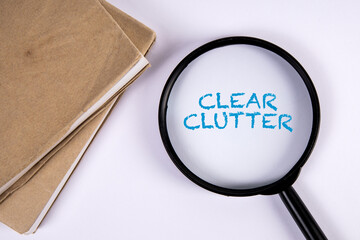 Clear Clutter. Magnifying glass and book on white background