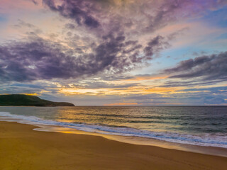 Sunrise seascape with clouds and gentle surf
