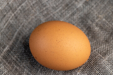 A clean whole orange chicken egg close-up on the table