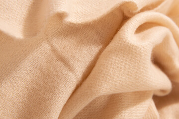 Natural wool creamy colored fabric. Cashmere, wool. Texture of natural wool fabric. Knitwear.