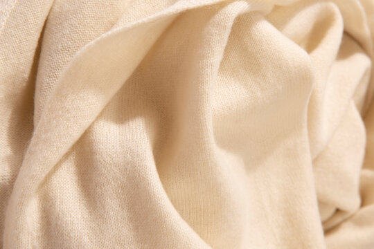 Natural wool yellow colored fabric. Cashmere, wool. Texture of natural wool fabric. Knitwear.