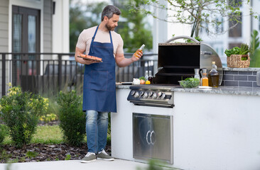 photo of barbecue man with salmon fish, copy space. barbecue man with salmon