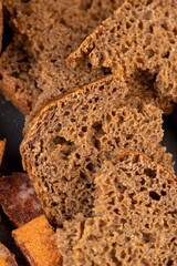 pieces of black rye bread from mixed wheat flour with rye flour