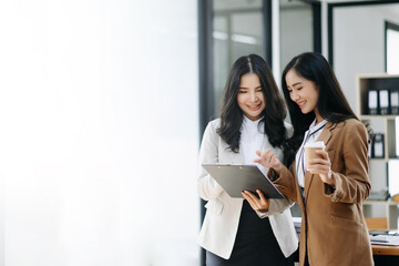 Kind leader executive manager share and discuss business solutions plan ideas on tablet with Asian...