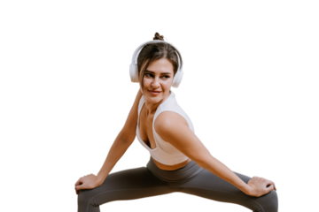 Young caucasian woman in sportswear using headphones, trains against transparent background, stretching. Fit Spanish girl at workout enjoys music, Lady doing exercises, maintains optimum weight